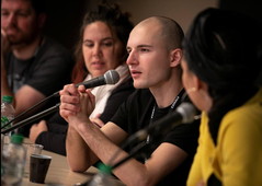 Alex Boya speaking at a panel discussion at Clermont-Ferrand Festival 2019 with CANAL+ branding and microphones