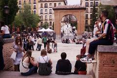 Crowd celebrating Fiestas del Dos de Mayo 2019 in Malasaña with flags and banners