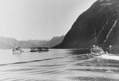 German tugboat towing a camouflage float near battleship Tirpitz in Fættenfjord Norway 1942