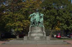 Monument of Johann Wolfgang von Goethe in a park with statues and autumn foliage