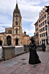 Statue of La Regenta by Mauro Álvarez Fernández in Plaza de Alfonso II el Casto, Oviedo with Gothic Santa Iglesia Basílica Catedral Metropolitana de San Salvador in background