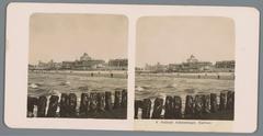 Historic black and white stereophotograph showing the Kurhaus hotel in Scheveningen from a breakwater circa 1900-1910