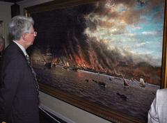 Man observing painting depicting flames and smoke from 1906 San Francisco earthquake and fire