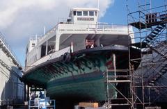 Ferryboat Eureka in drydock on blocks undergoing maintenance with paddlewheels visible