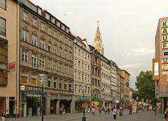Busy Kaufinger Strasse shopping street in Munich with historic buildings and people walking, looking east towards Marienplatz