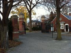 Main gates of Upper Canada College with stone pillars and metal arch