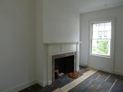 Mantle and wooden floorboards in an upstairs room at The Grange, Hamilton Grange