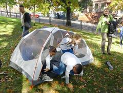 Children learning to put up a tent during Every Kid in a Park opening ceremonies in Harlem, NYC