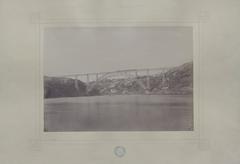 Metallic bridge over Douro river with a train passing in Portugal