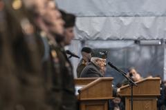 World War II veteran John Jack Foy giving a speech alongside active U.S. Army soldiers at the 80th anniversary Battle of the Bulge ceremony at Luxembourg American Cemetery