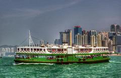 Star Ferry crossing Victoria Harbour in Hong Kong with city skyline in the background