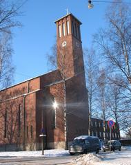 St. Paul's Church in Helsinki exterior with green dome and red brick facade
