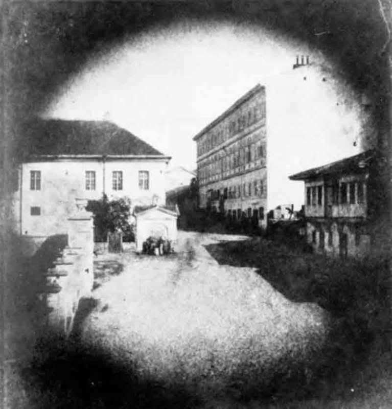 Historic street view of Kralja Petra Street in Belgrade in 1865, featuring the first Belgrade Primary School building with the first Reading Room on the left and the hotel Kod Jelena housing the Ilirska kasina