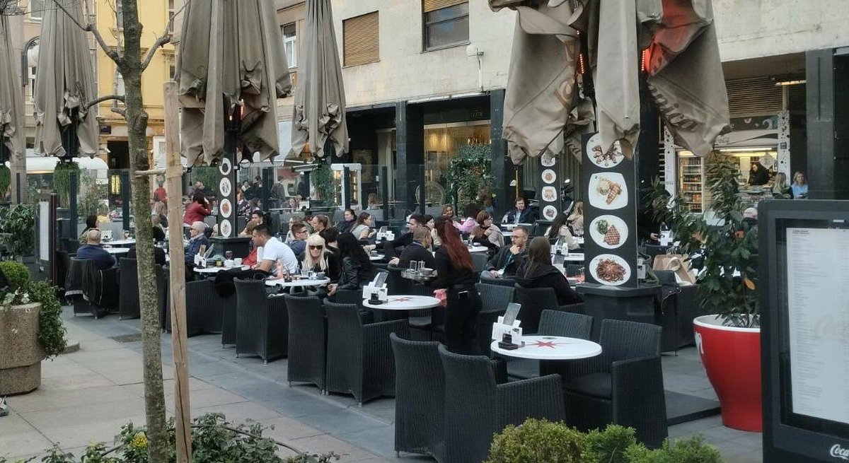 Croatians enjoying coffee at an outdoor café on Flower Square in Zagreb