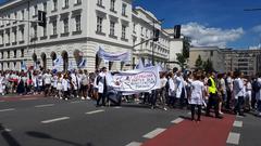 Protesters at a demonstration in Warsaw holding banners and signs