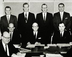 Early board of trustees group photo at Alaska Methodist University in Anchorage, Alaska, featuring Dr. Meredith Groves, John R. Connolly, Bishop A. Raymond Grant, Dr. Frederick P. McGinnis, Wally Hickel, Bob Atwood, Rev. David Blackburn, and E. D. McDonald
