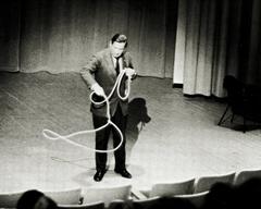 Will Rogers, Jr. demonstrating lasso tricks on stage at Alaska Methodist University in 1967