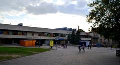 Vilnius central bus station building with vehicles and people outside