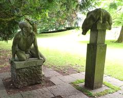 Sculpture by Michael Quane depicting a figure talking to a quadruped in the grounds of University College Cork