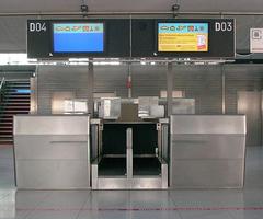 Airport check-in counter with multiple service desks and seating area