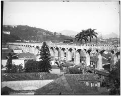 Arcos da Lapa historic aqueduct in Rio de Janeiro lit up at night with street views
