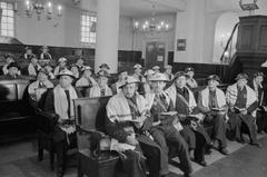 Members of Civil Defence wearing steel helmets and prayer shawls at Great Synagogue service, London 1941