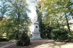 Wildermuth-Denkmal monument on Neckar island in Tübingen with lush green trees and clear sky