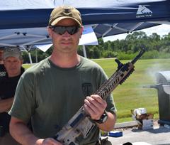 U.S. Marine Corps Lt. Col. Aaron Brunk holding his new AR-15 rifle at the D-Day Shoot-Out event on MacDill Air Force Base