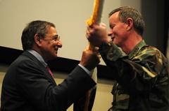 Secretary of Defense Leon E. Panetta handing the U.S. Special Operations Command flag to U.S. Navy Adm. William H. McRaven during change of command ceremony at MacDill Air Force Base, August 8, 2011