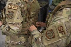 U.S. Air Force female installation patrolmen adjusting improved female-specific body armor at MacDill Air Force Base