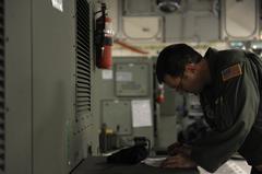 U.S. Air Force Master Sgt. Jeff Wilson reviewing cargo manifest before earthquake relief mission