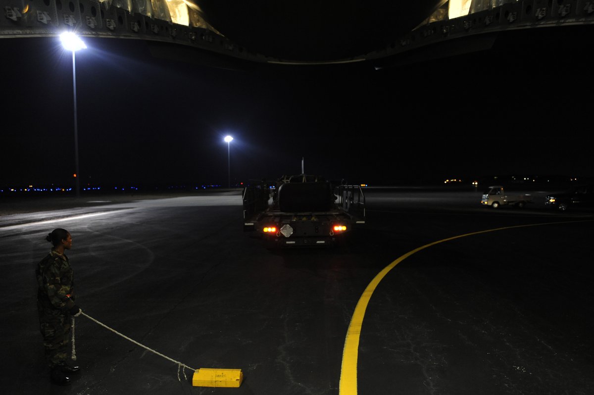 U.S. Air Force Tech. Sgt. monitoring K-loader bringing earthquake relief supplies to C-17 Globemaster III