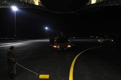 U.S. Air Force Tech. Sgt. monitoring K-loader bringing earthquake relief supplies to C-17 Globemaster III