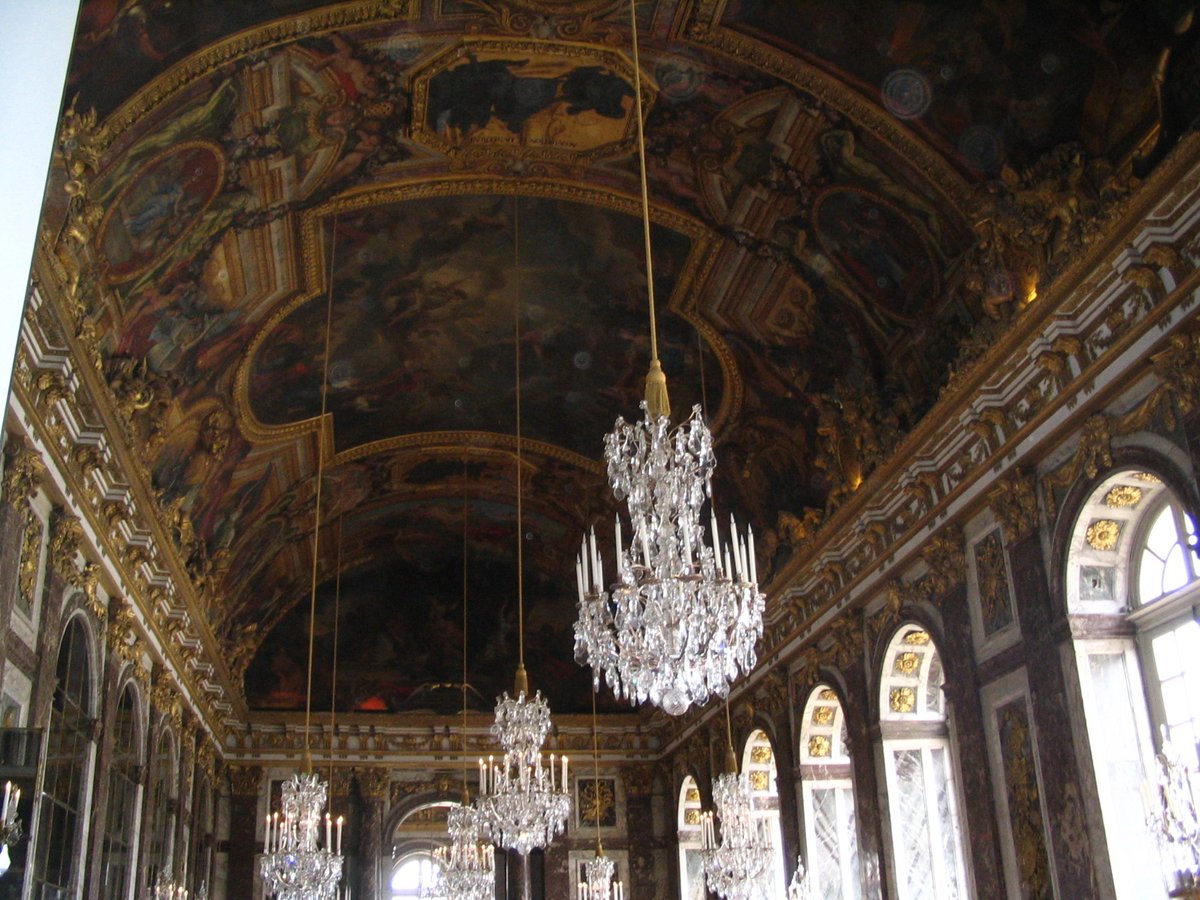 Front view of the Palace of Versailles in 2005 with ornate architecture under a blue sky