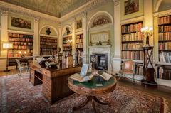 Interior view of the old library with ornate wooden shelves filled with books at Harewood House in Leeds, Yorkshire, England