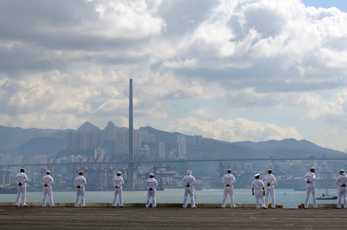 Sailors standing on the rails of USS George Washington aircraft carrier during port visit in Hong Kong