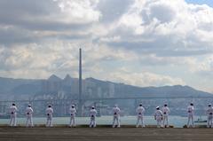 Sailors standing on the rails of USS George Washington aircraft carrier during port visit in Hong Kong