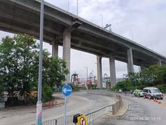 Stonecutters Island Container Port Road South with Stonecutters Bridge and Tsing Sha Highway flyover in Hong Kong June 2024