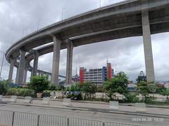 Stonecutters Bridge and Tsing Sha Highway flyover at Stonecutters Island Container Port Road South in Hong Kong with urban infrastructure in June 2024