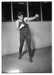 Black and white portrait of Firpo, a boxer, showing his muscular upper body
