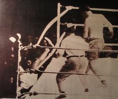 Argentinian boxer Luis Ángel Firpo knocking American boxer Jack Dempsey out of the boxing ring during their match on September 14, 1923