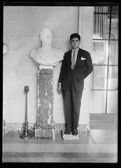 Louis Angel Firpo holding bust of Sam Martin Argentine national hero