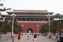 Aerial view of the Forbidden City in Beijing, China, showcasing its ancient palaces and traditional Chinese architecture under a clear blue sky