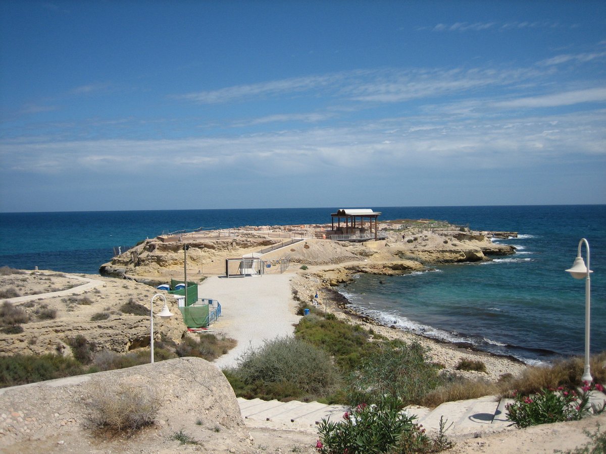 Aerial view of La Isleta peninsula near Campello, Spain with coastline and ocean