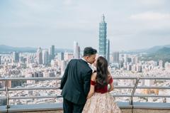 Couple kissing with Taipei city skyline in the background viewed from Shangri-La Far Eastern Hotel