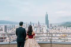 View of Taipei city skyline from Shangri-La's Far Eastern Plaza Hotel with couple Ken and Helen standing and looking at the view from behind