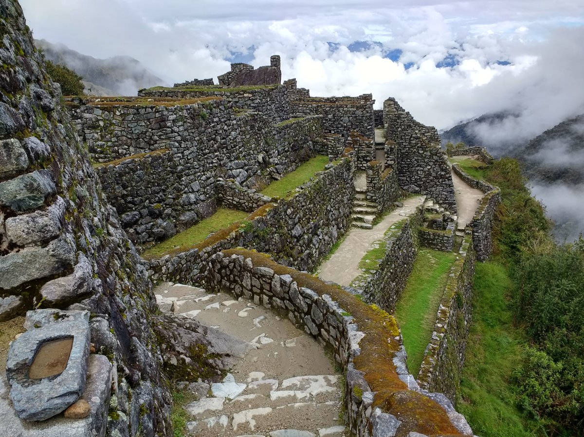 Ruins of Sayacmarka along the Inca Trail with stone structures set on a mountainous landscape