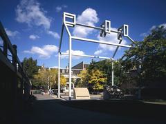 White steel frame outlining Benjamin Franklin's historic home site in Franklin Court surrounded by greenery and blue sky