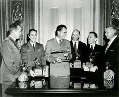 Vice-President Richard M. Nixon presenting the 1958 Robert J. Collier Trophy holding a Lockheed F-104 Starfighter model alongside trophy recipients