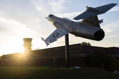 F-104 plane static display with birds perched at sunrise and air traffic control tower at McGhee Tyson Air National Guard Base